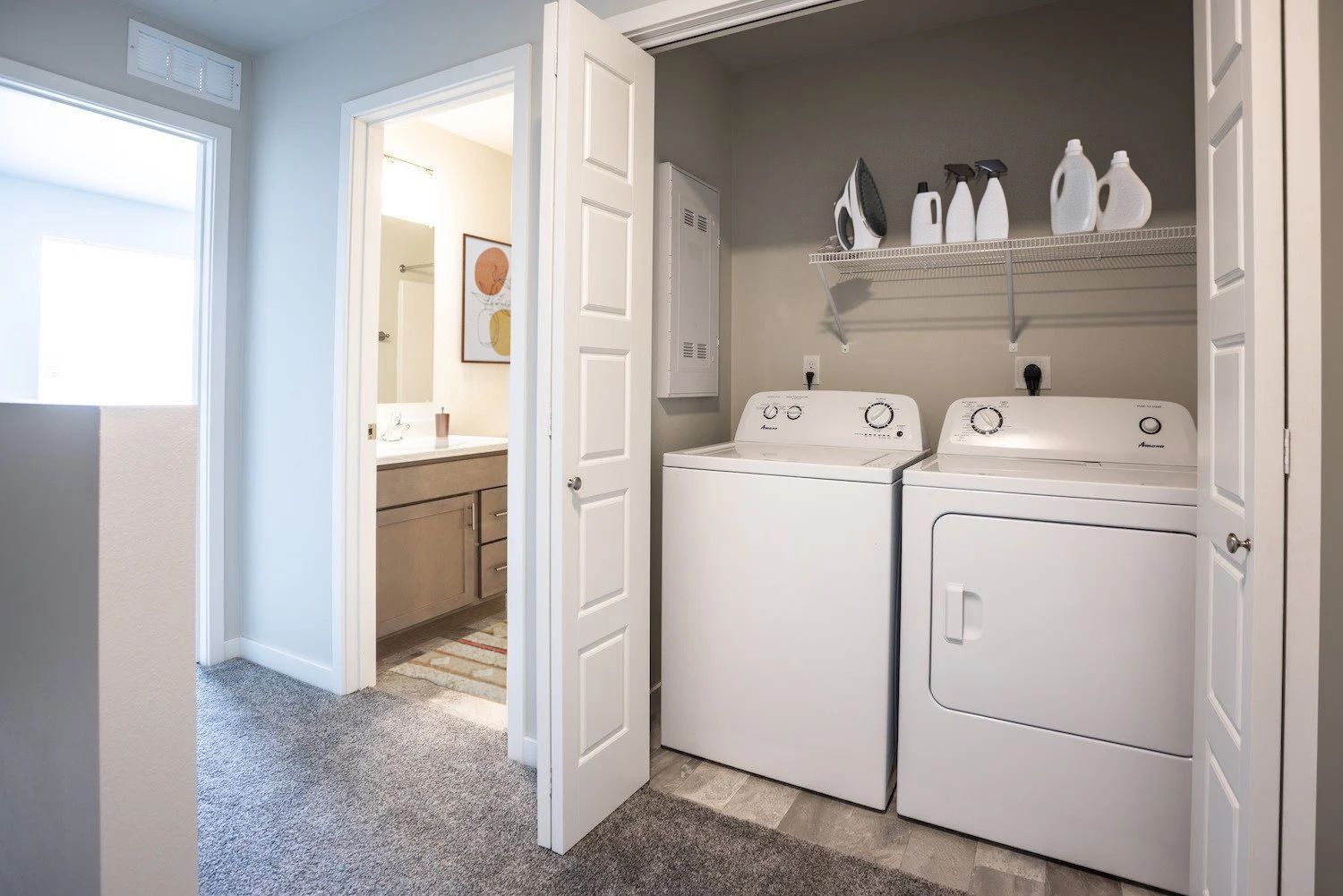 A laundry room with a washer and dryer in a closet.