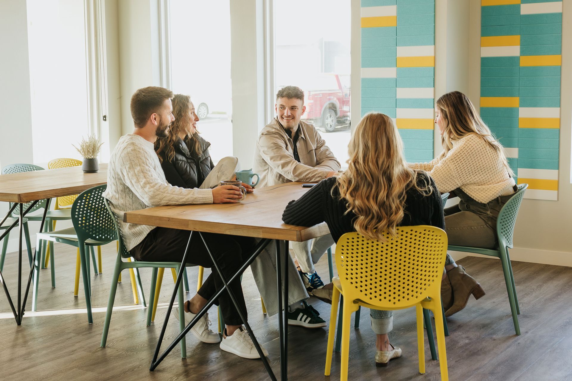 People sitting in the clubhouse table and chairs.