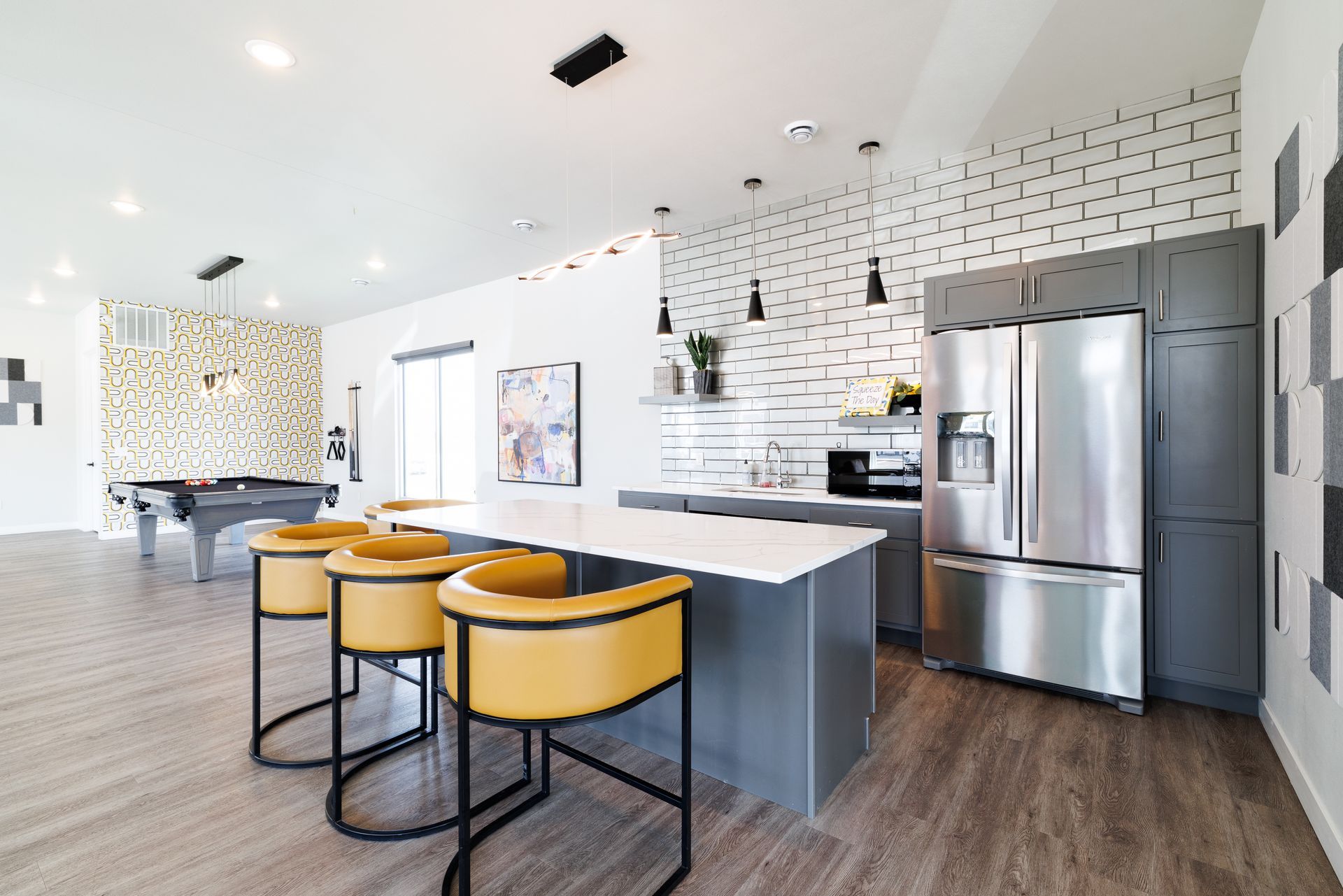 Clubhouse kitchen with island and stools.