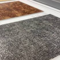 Gray and brown textured material samples on a white surface.