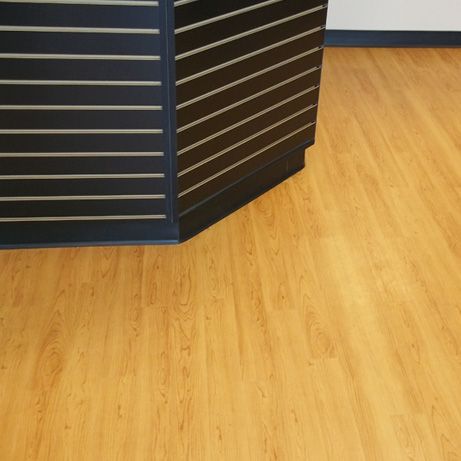 Wooden floor with a dark-paneled cabinet.