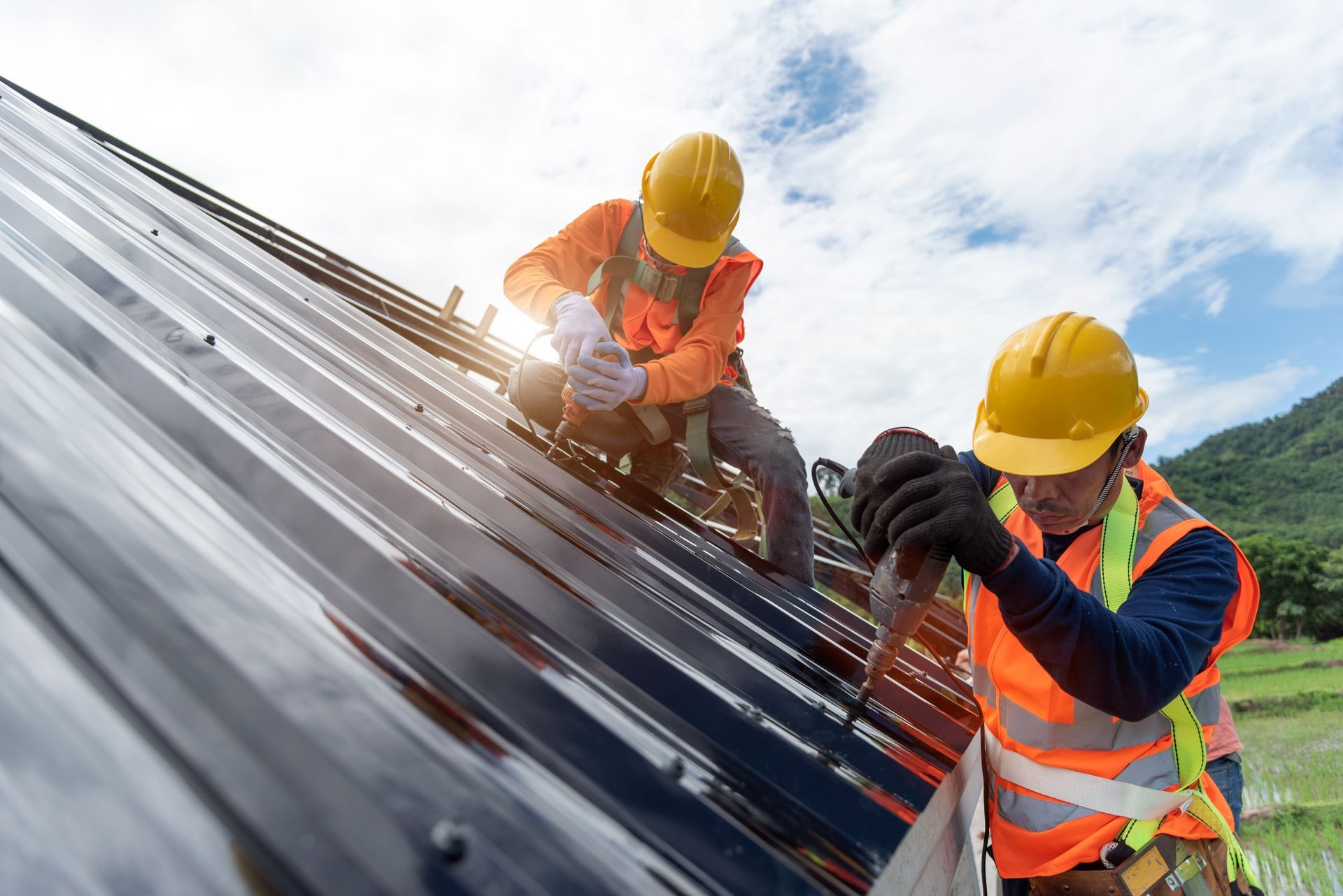 Two Construction Workers Are Working on a Roof