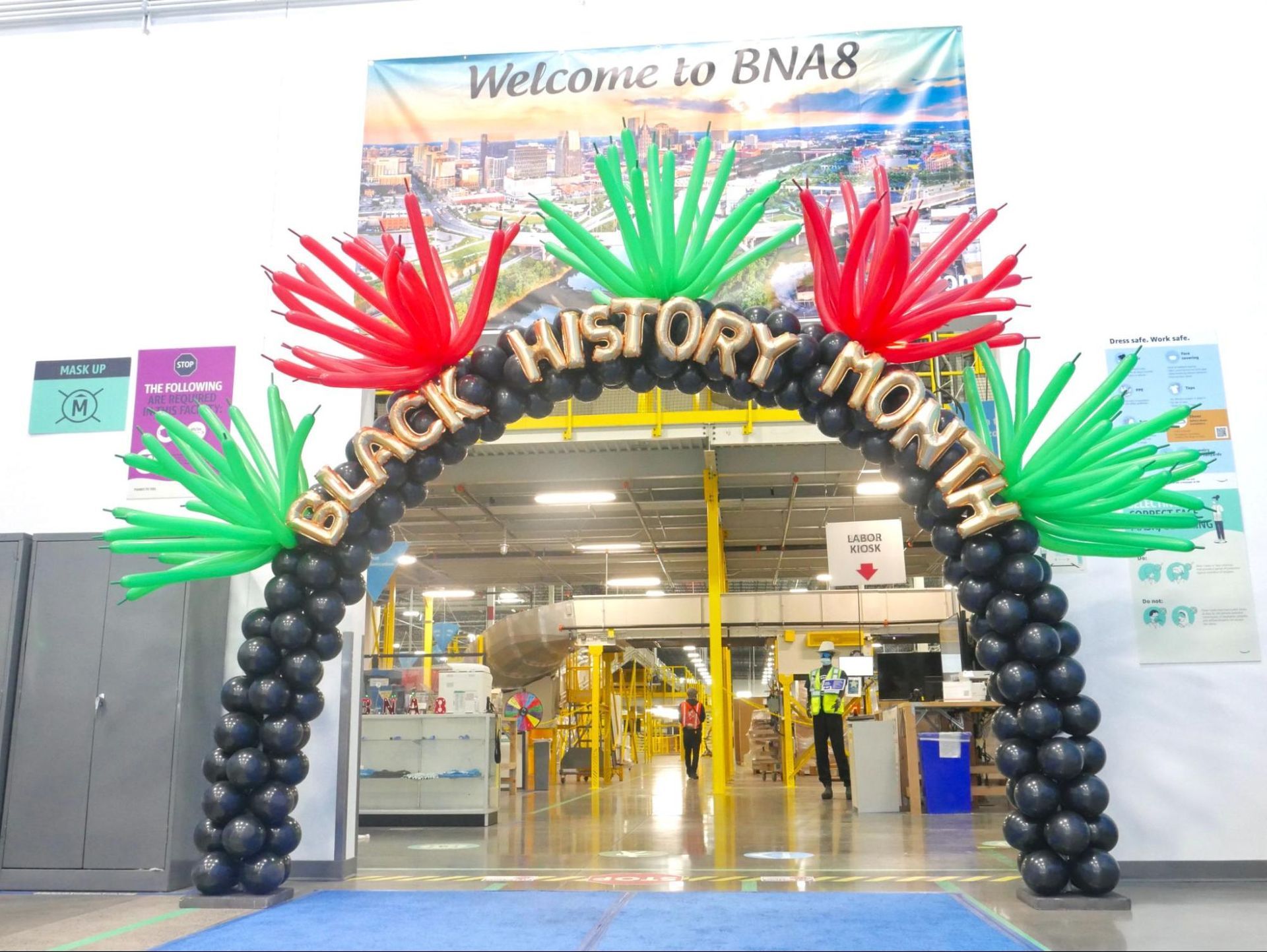 A black history month balloon arch in a warehouse