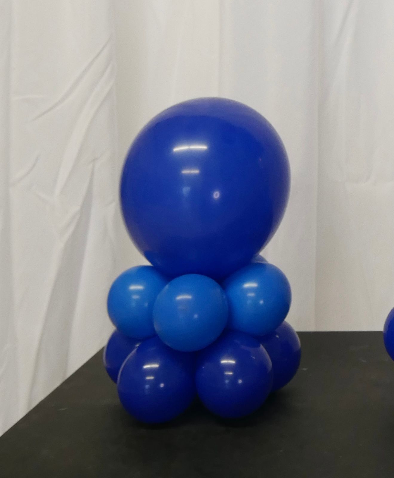 A bunch of blue balloons stacked on top of each other