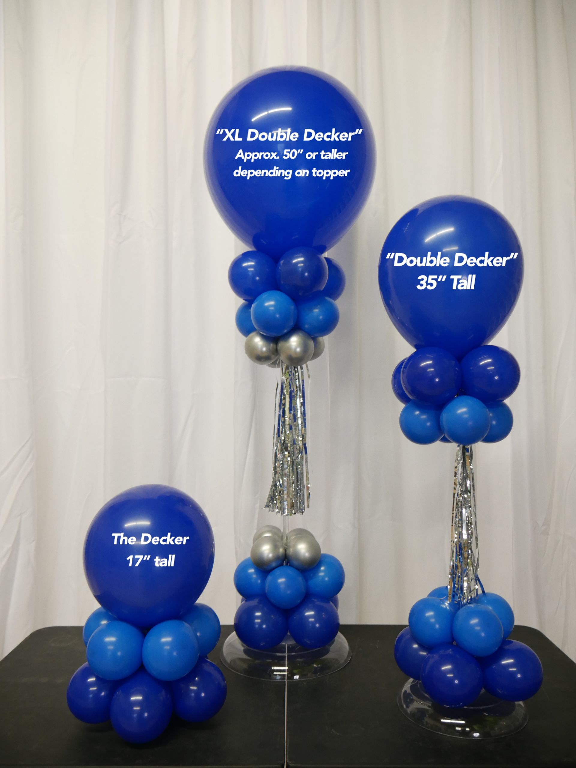 Three blue balloons with the words double decker on them