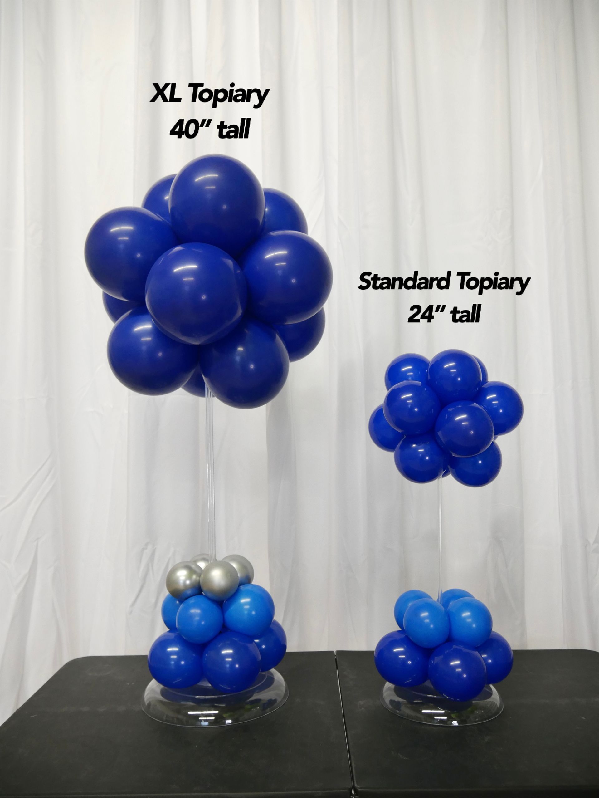 A table with blue balloons and a sign that says xl tapiery 40 