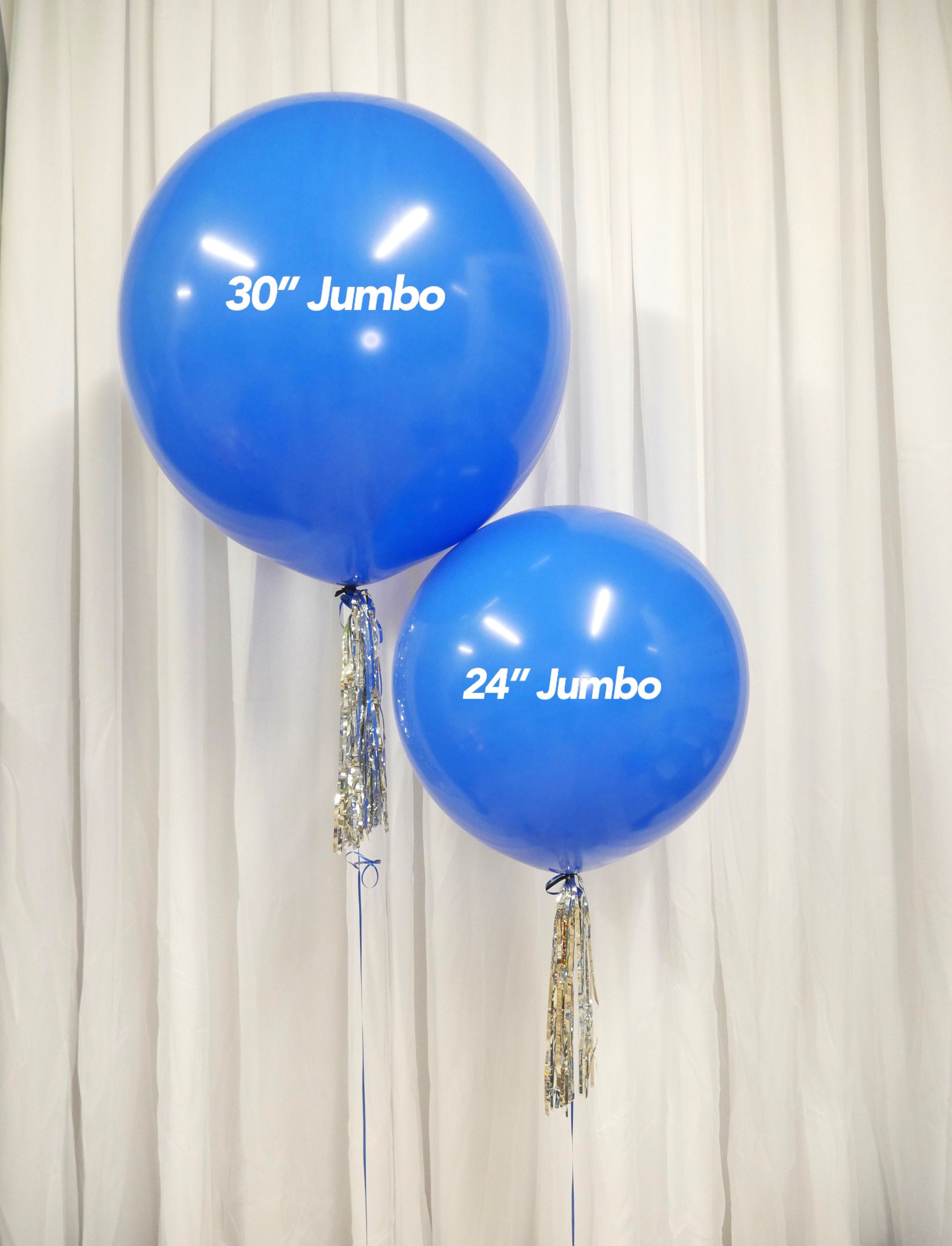 Two blue jumbo balloons are sitting next to each other