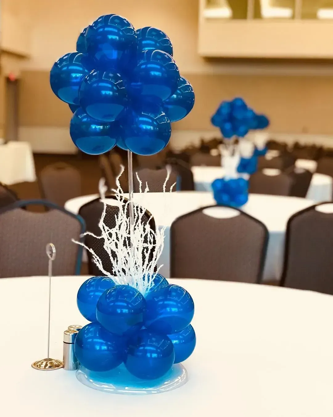 A bunch of blue balloons are sitting on a table