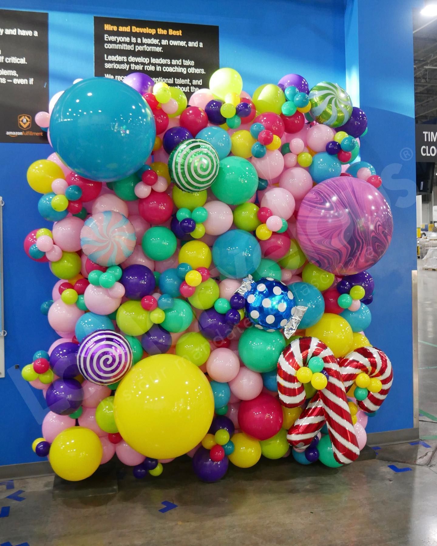 A wall of colorful balloons and candy canes