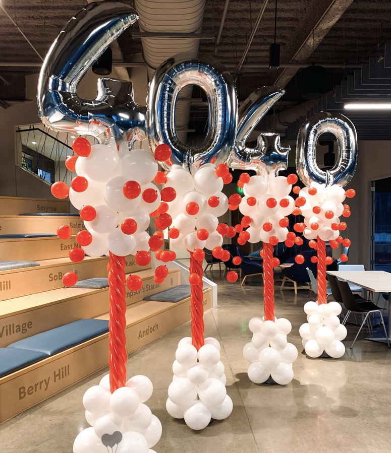 A bunch of balloons are sitting on top of each other in a room.