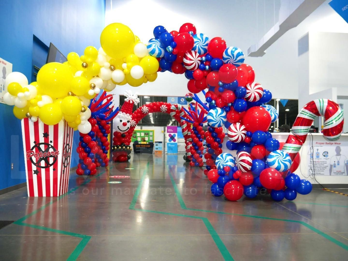 A room decorated with red white and blue balloons and candy canes
