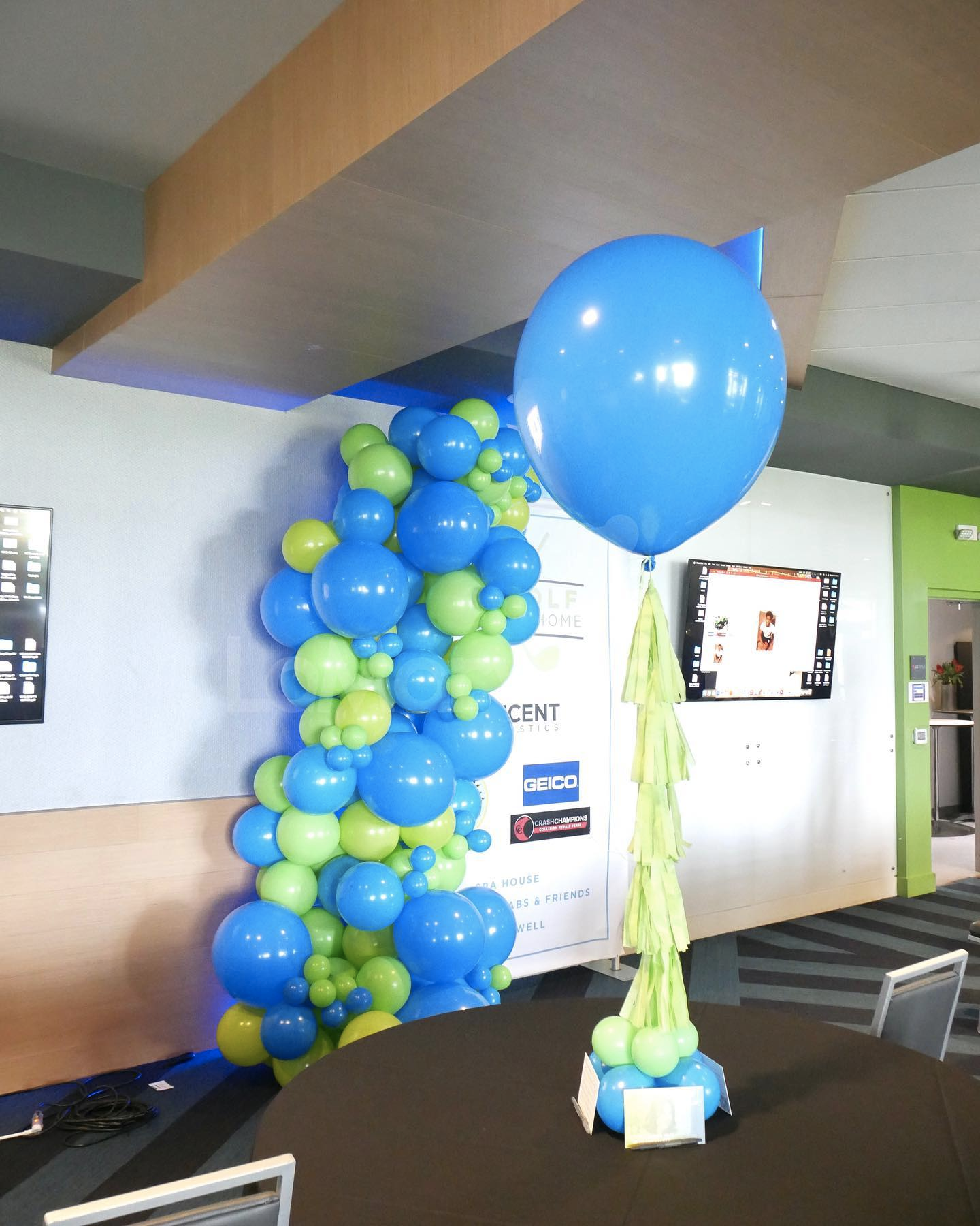 A blue balloon is sitting on a table in a room