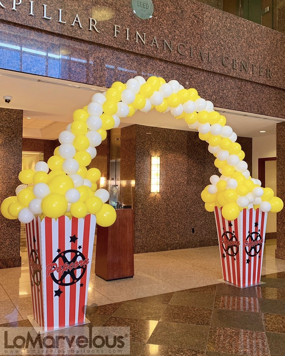 A pillar finance building is decorated with balloons and popcorn