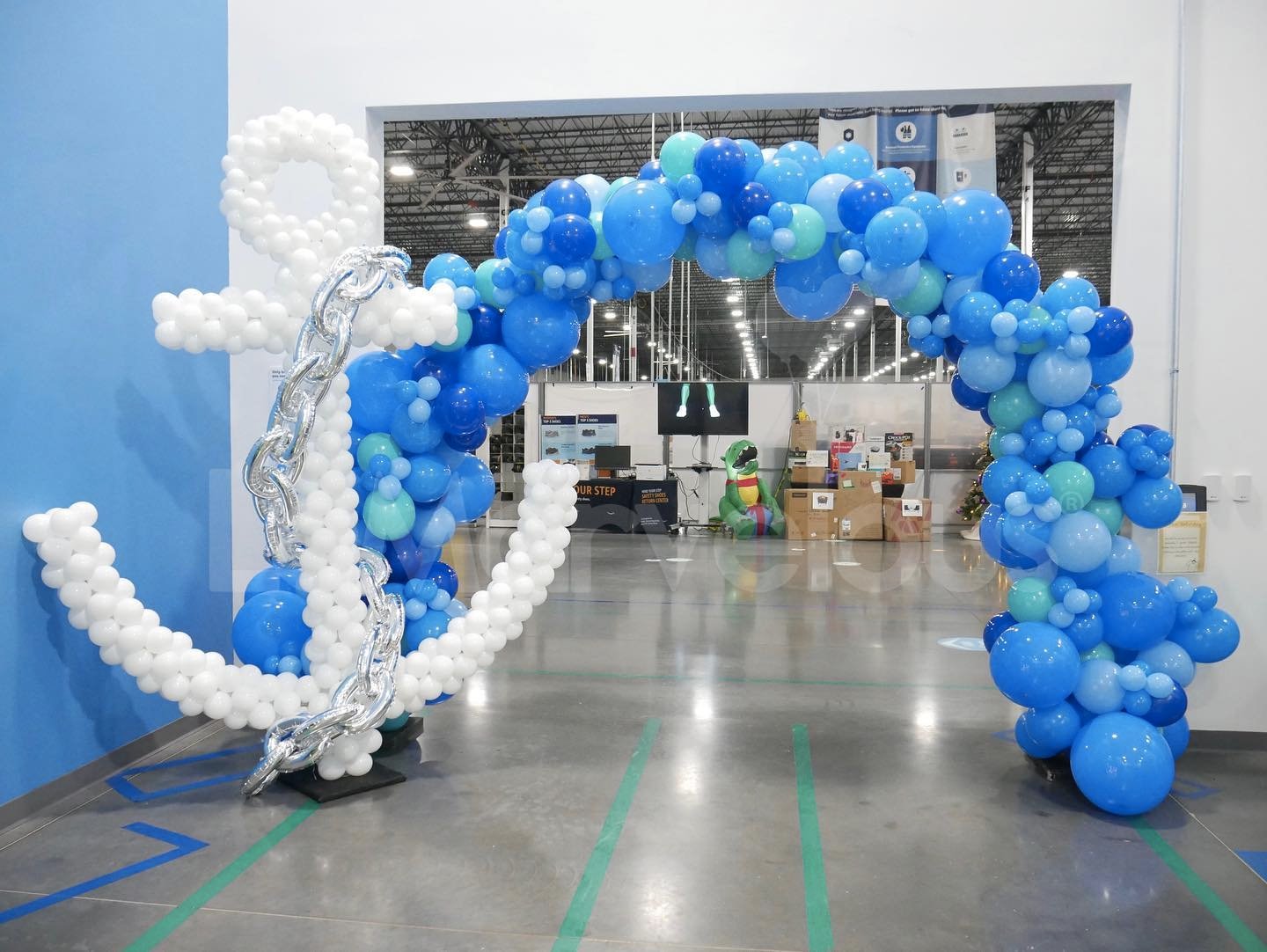 A blue and white balloon arch with an anchor made out of balloons.