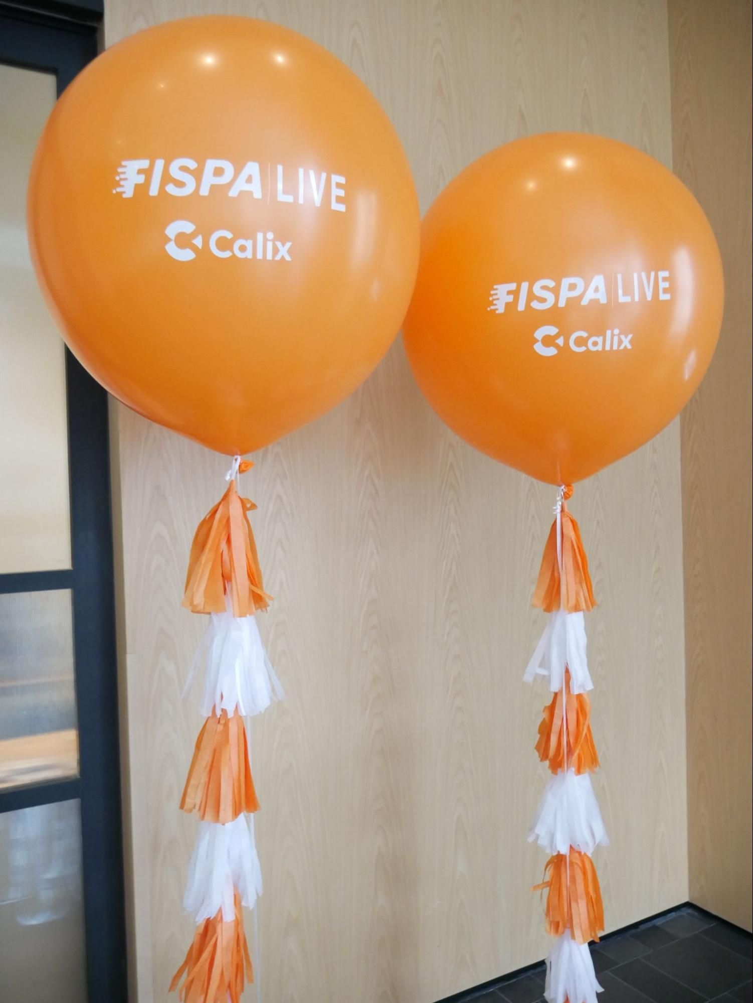 Two orange balloons with the words fispa live on them