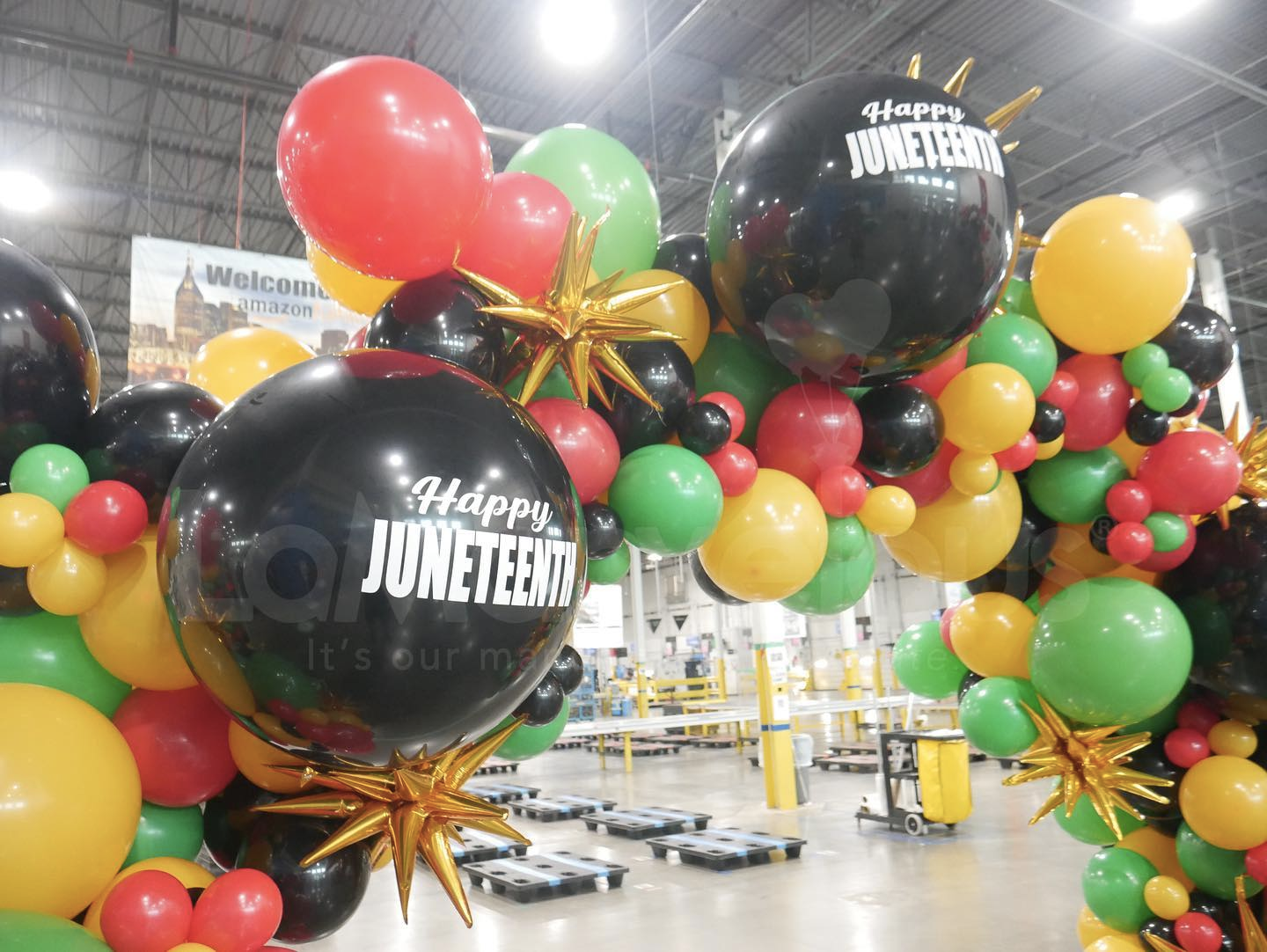 A bunch of balloons with one that says happy juneteenth