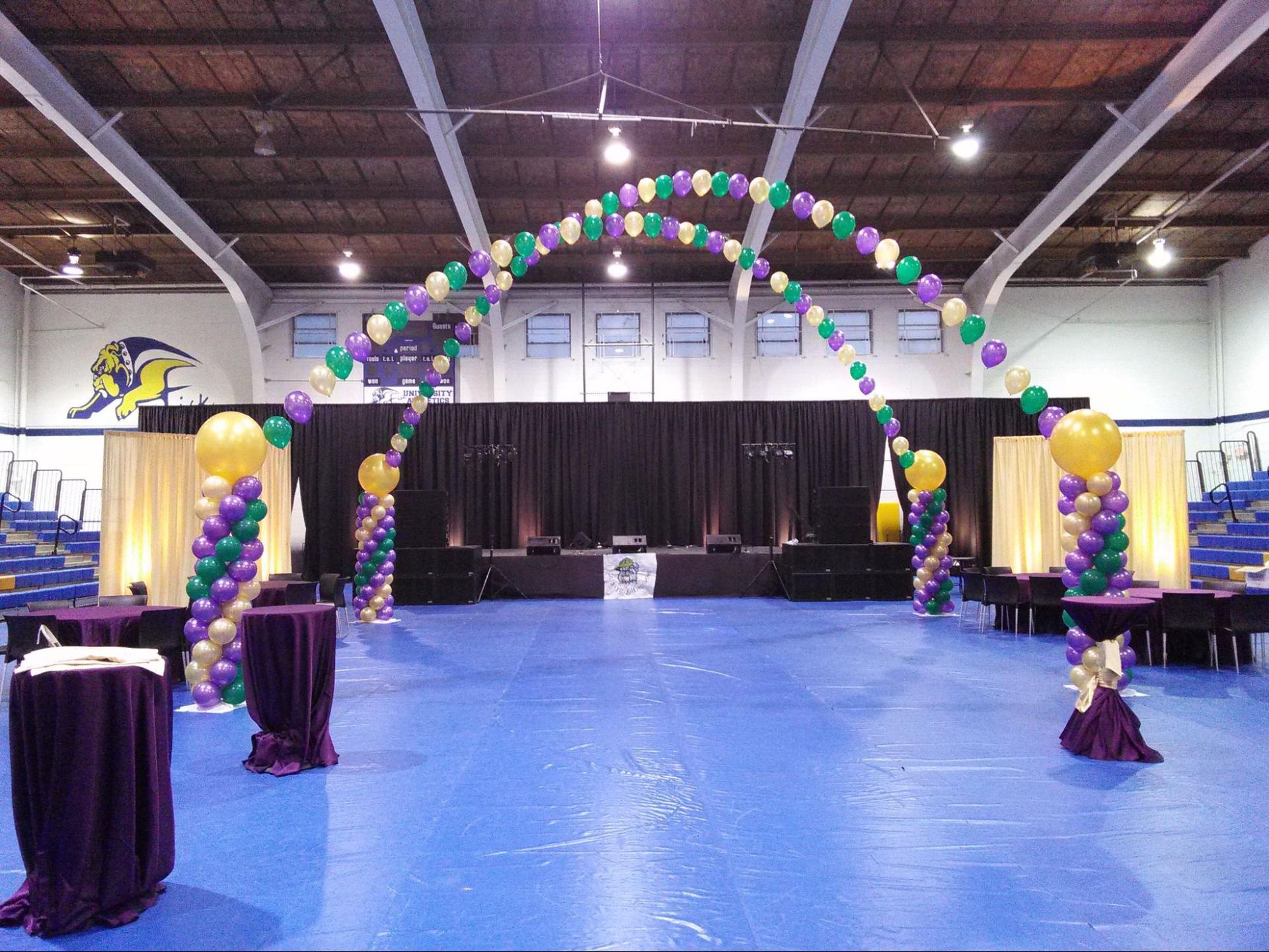 A large room with tables and balloons in it