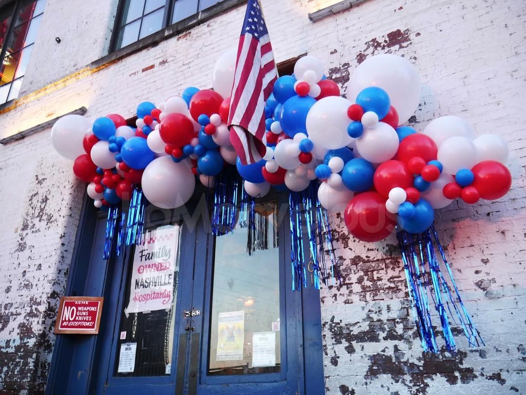 A building with red , white and blue balloons on it