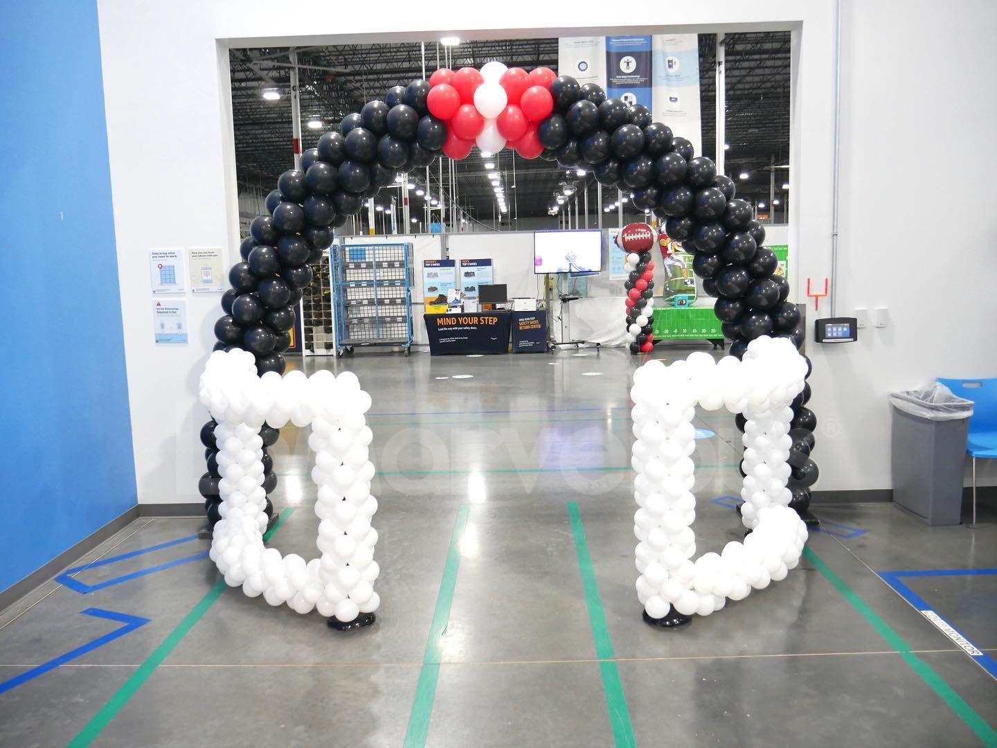 A black and white balloon arch in a store