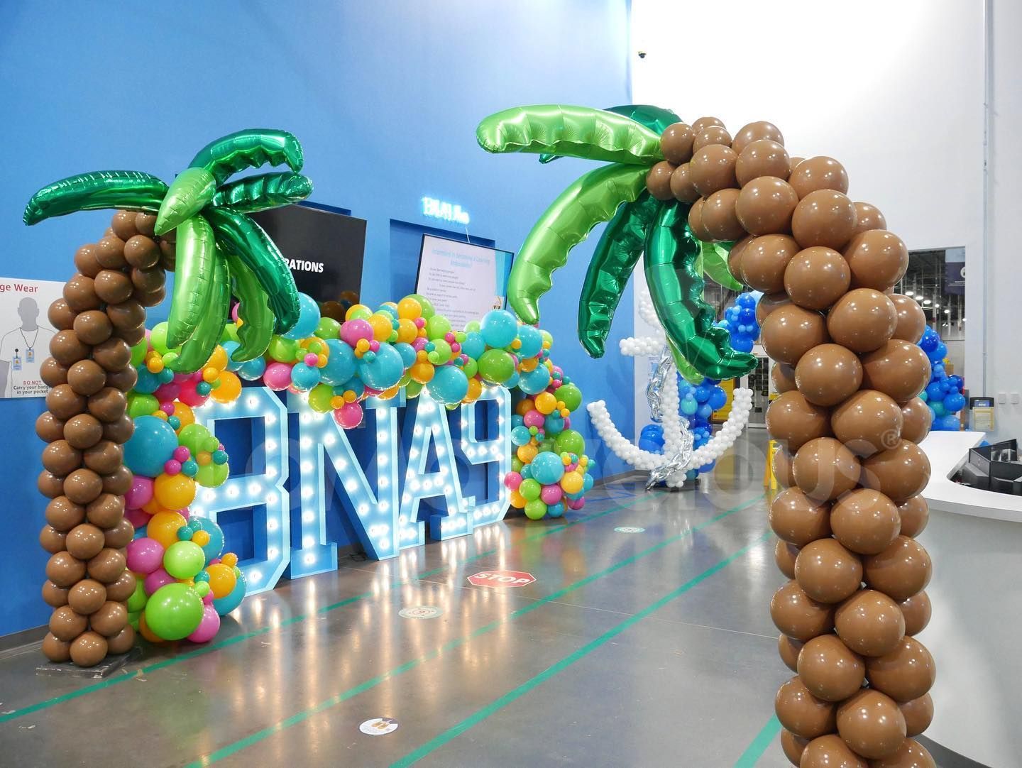 A room filled with balloons and palm trees.
