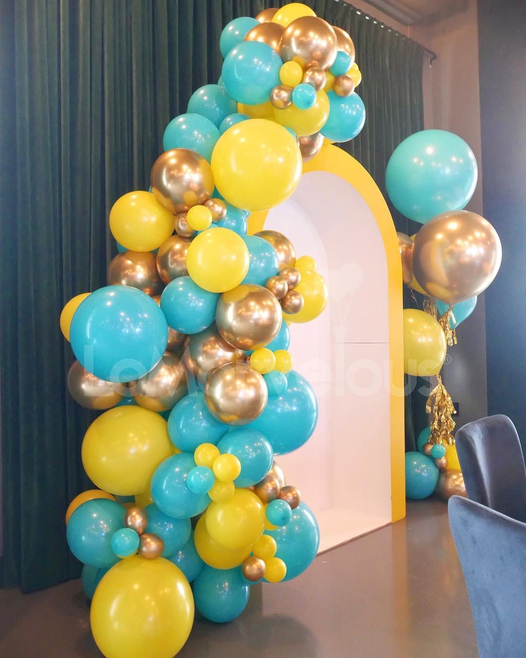 A bunch of balloons are sitting on the floor in a room.
