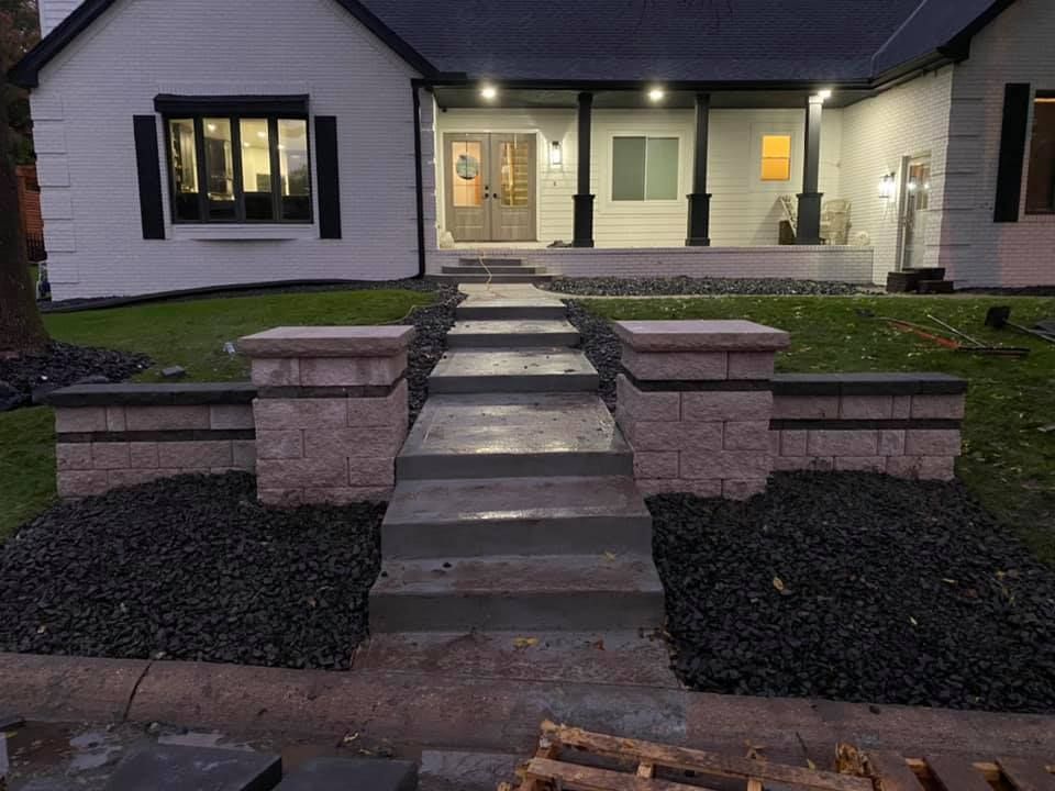 A white house with a walkway leading to the front porch