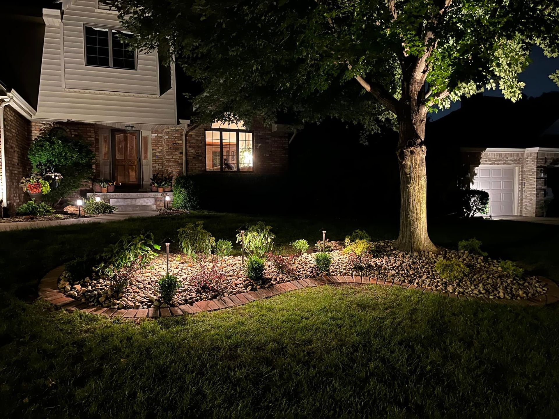The front of a house is lit up at night.