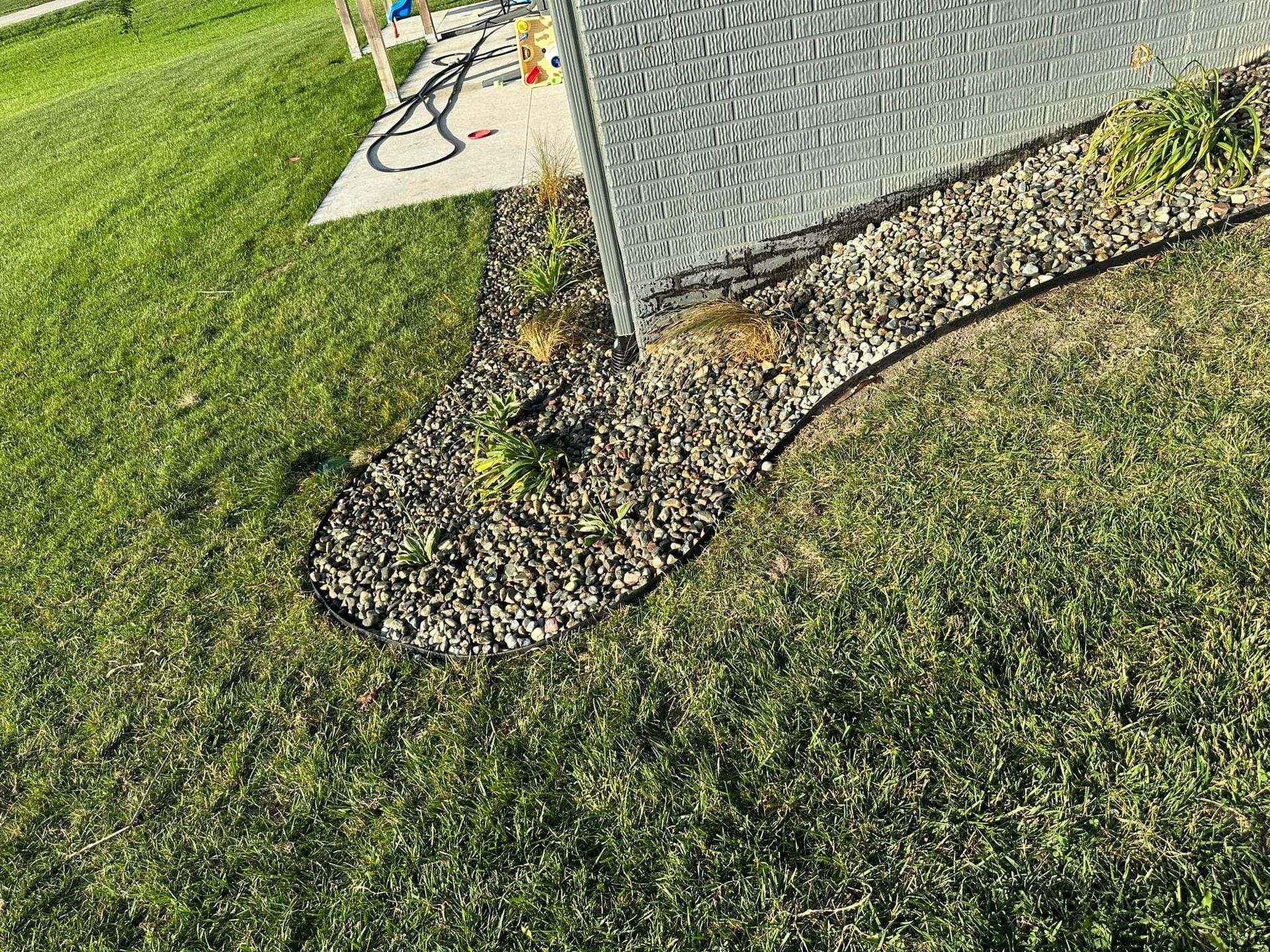 A chain link fence is surrounded by a lush green lawn.