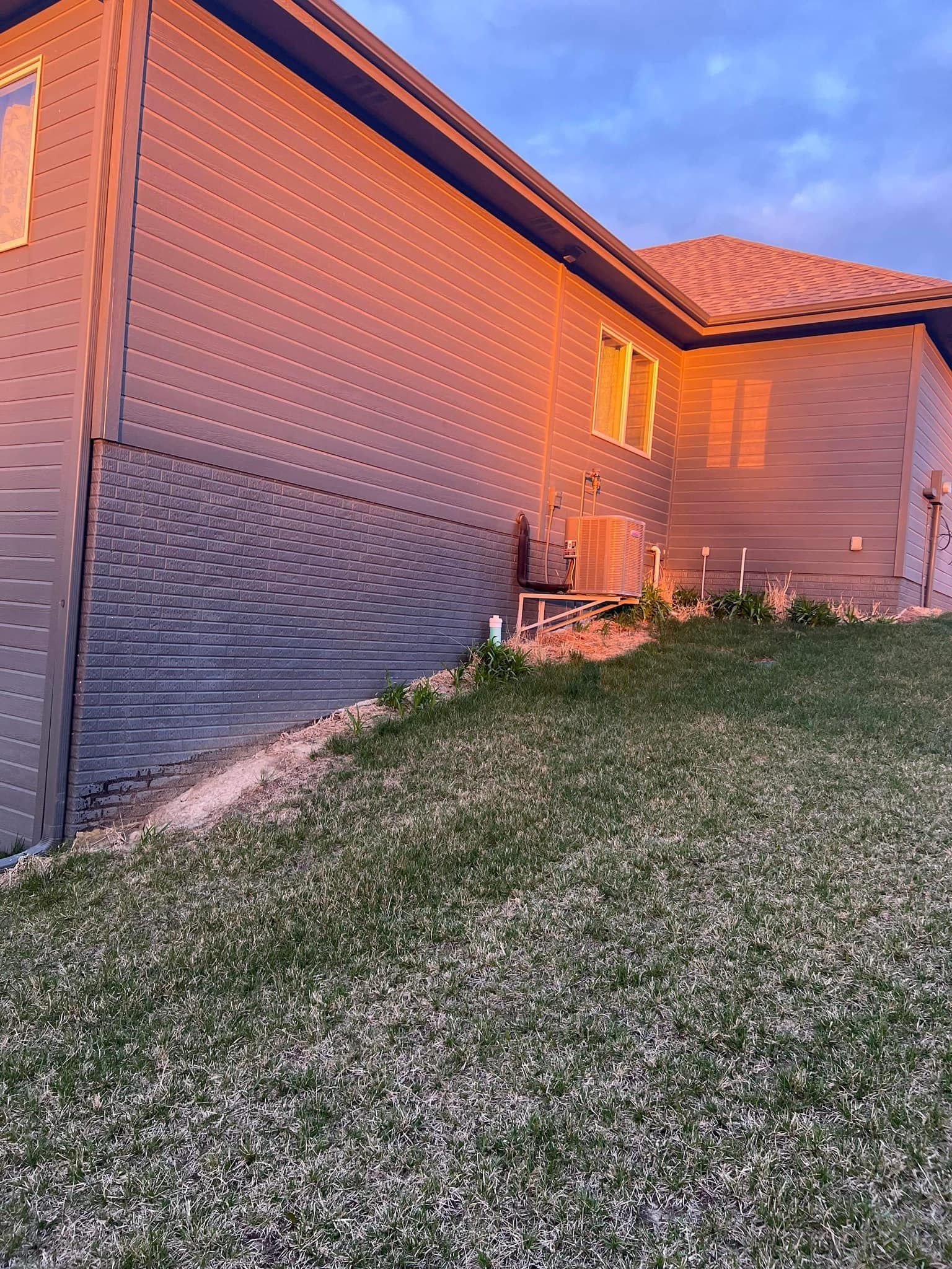 A house with a lot of grass in front of it.