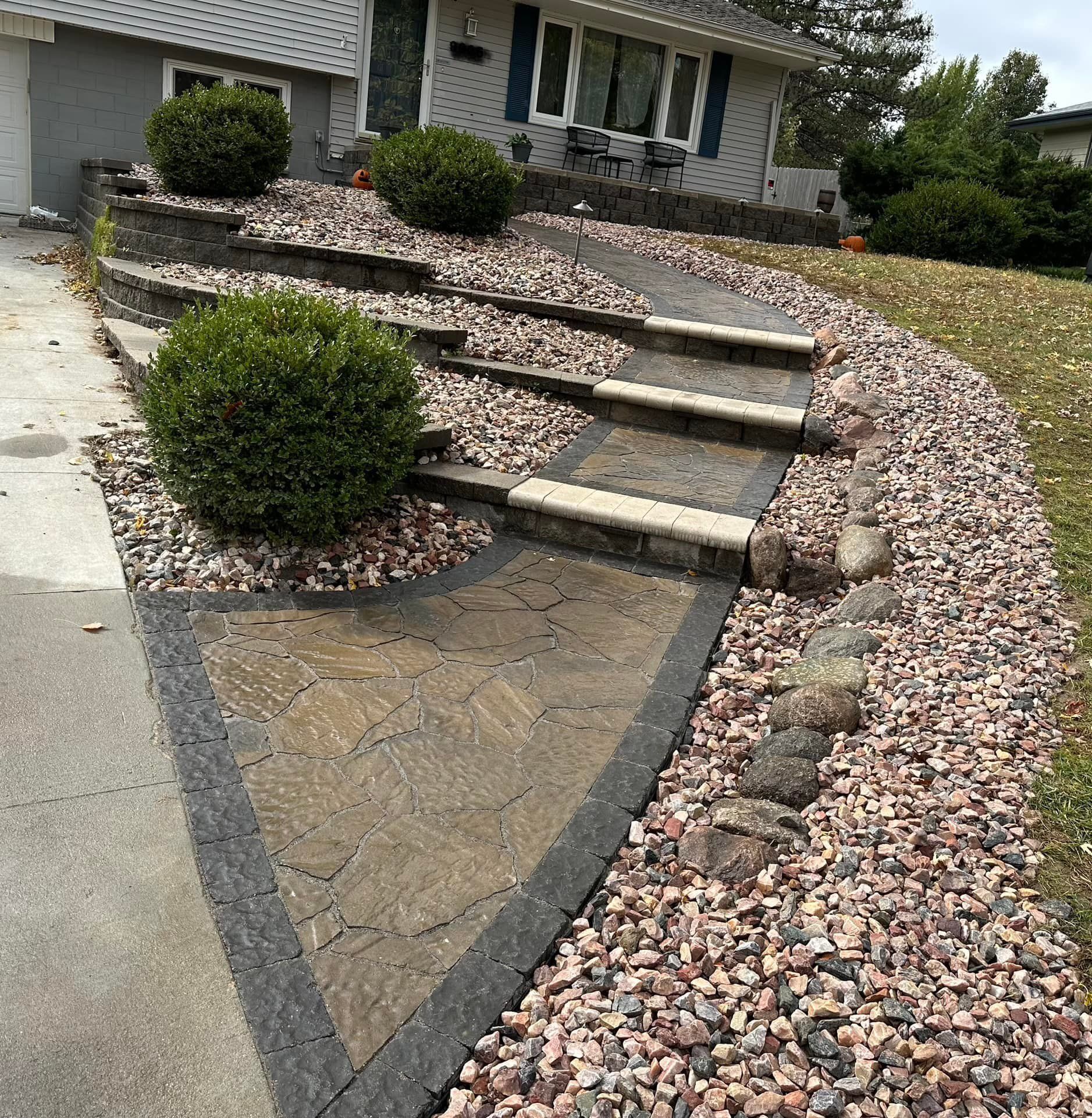 A stone walkway with steps leading up to a house