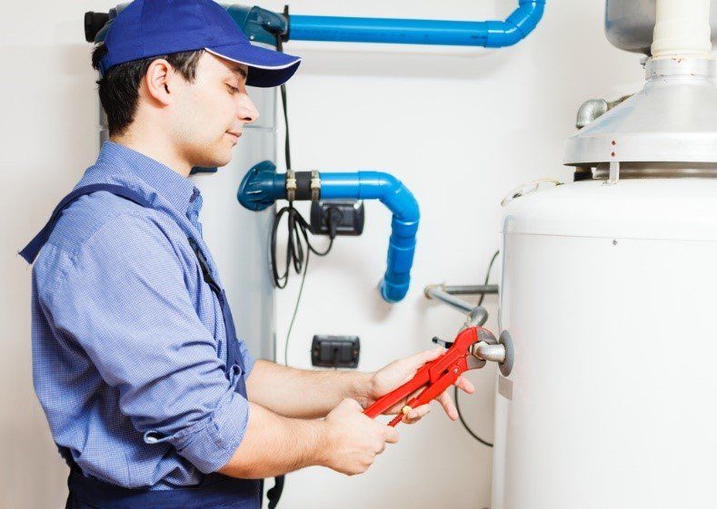 Water Heater — Worker Repairing Water Heater Tank in Clearwater, FL