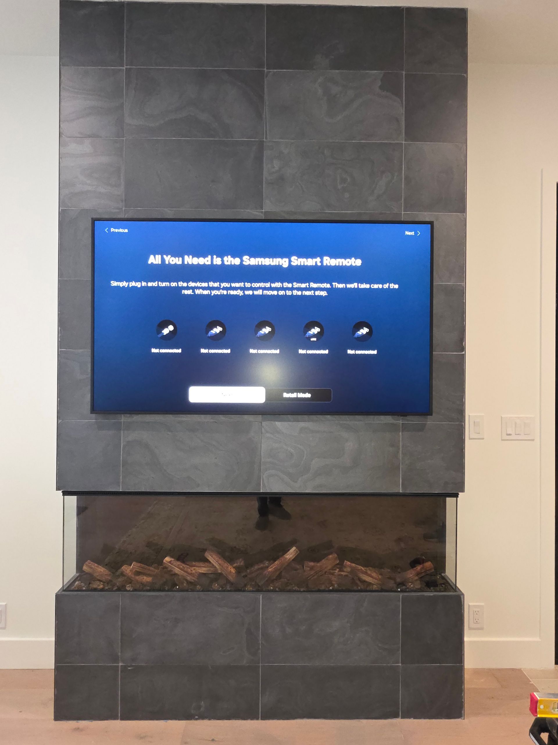 Woman in straw hat smiles, holding wine glass near a lake.