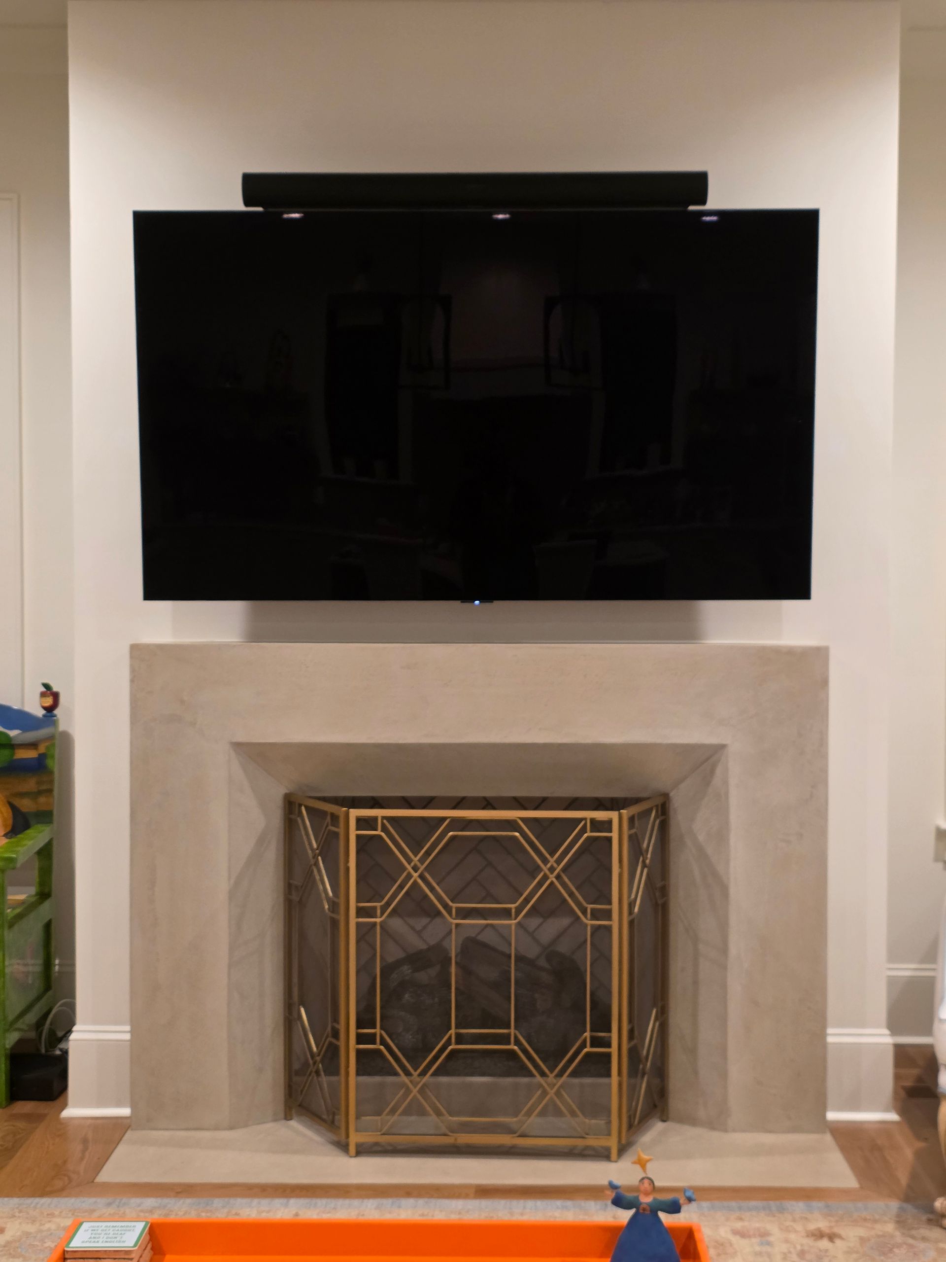 Woman in straw hat smiles, holding wine glass near a lake.