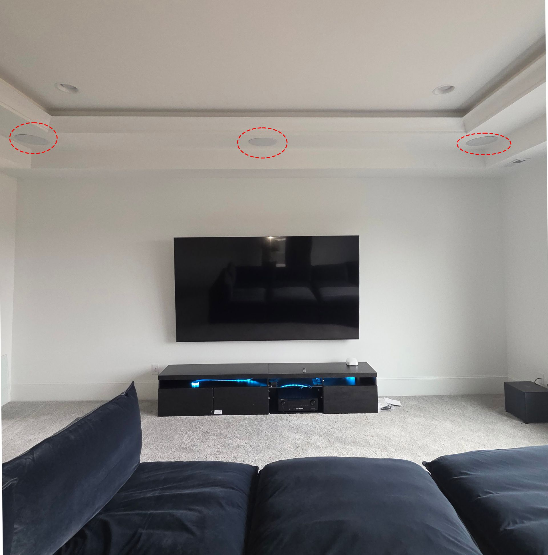 Woman in straw hat smiles, holding wine glass near a lake.