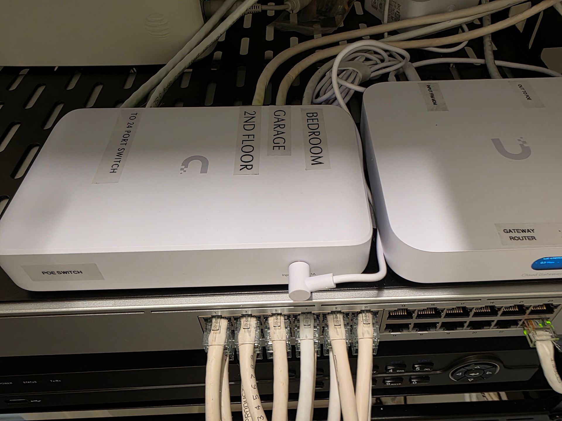 Woman in straw hat smiles, holding wine glass near a lake.