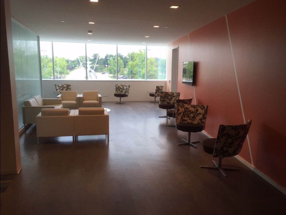 A room with a lot of chairs and a couch