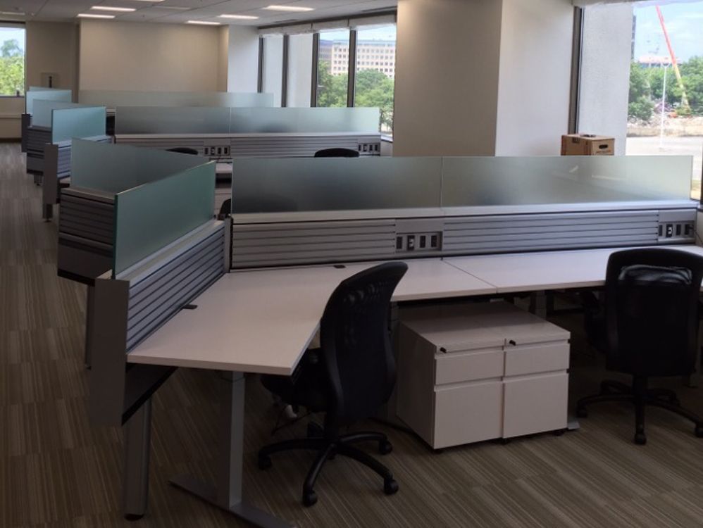 A row of cubicles in a large office building