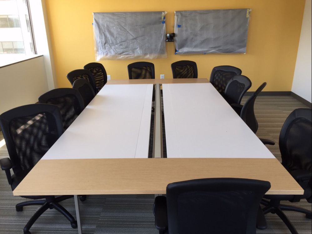 A conference room with a long table and chairs
