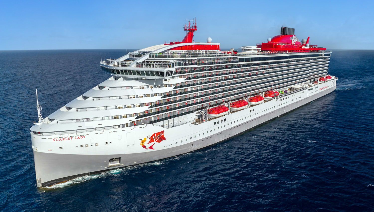 A large cruise ship is floating on top of a body of water.