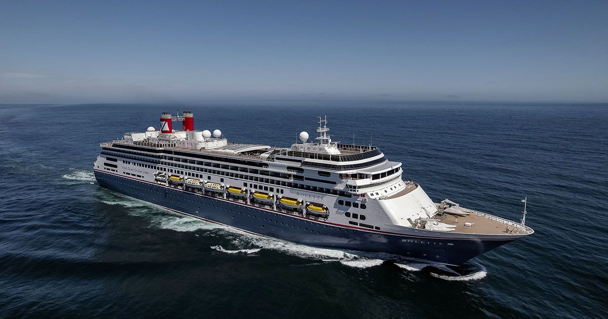 A large cruise ship is floating on top of a large body of water.