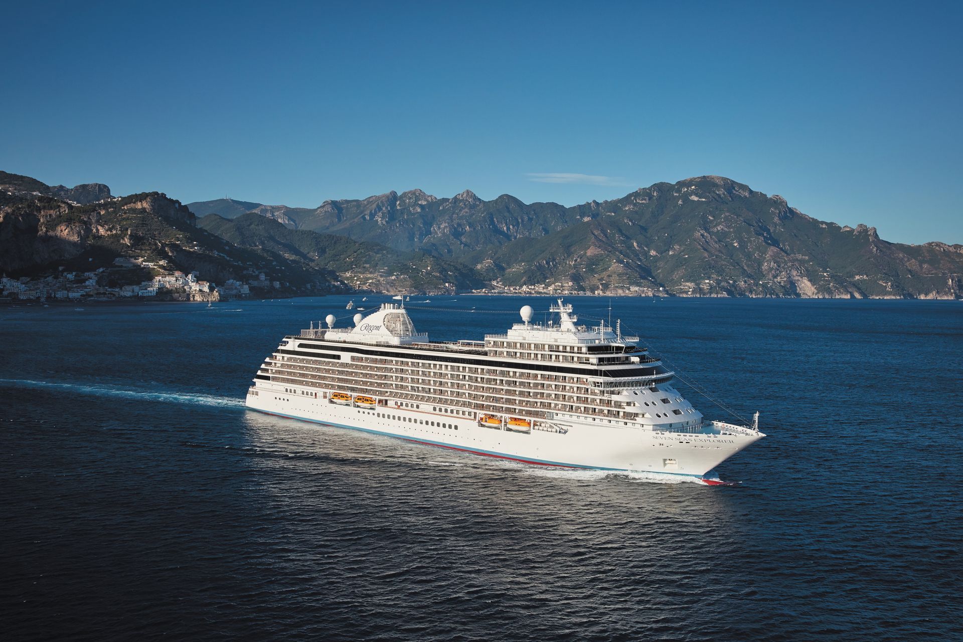A large cruise ship is floating on top of a body of water.