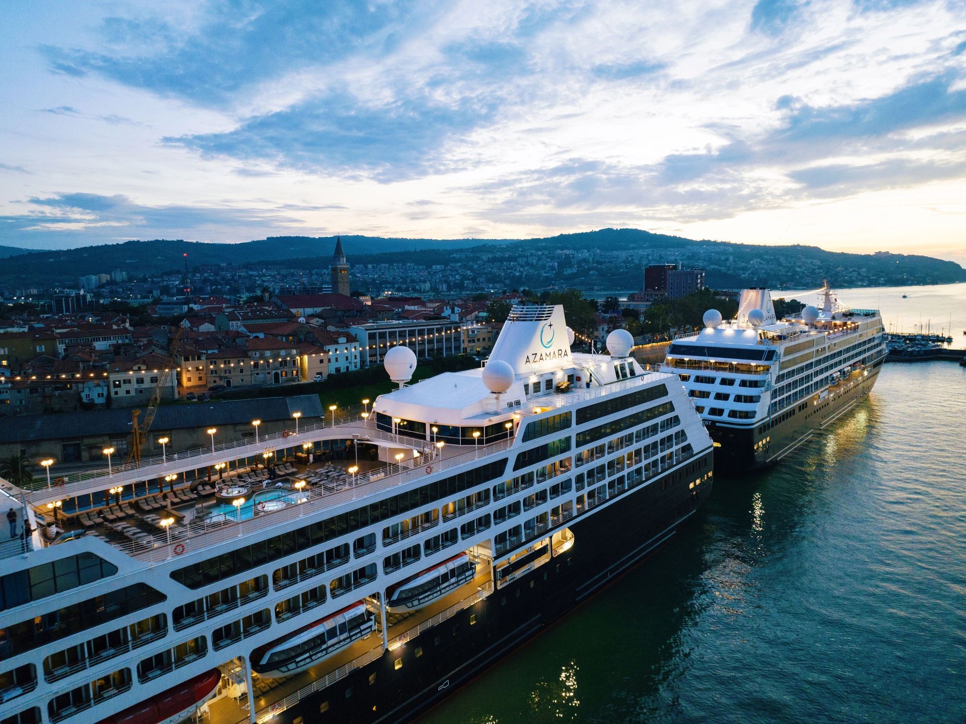 A couple of cruise ships are docked in a harbor.