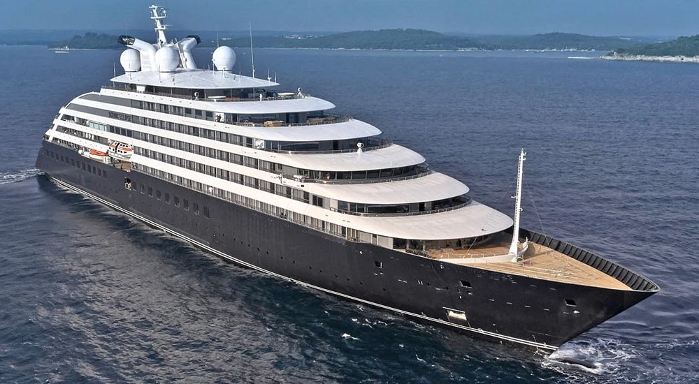 A large cruise ship is floating on top of a body of water.