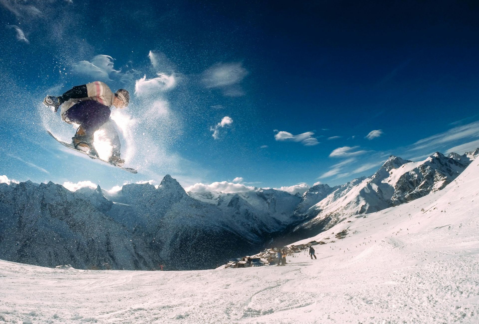 A snowboarder is doing a trick in the air
