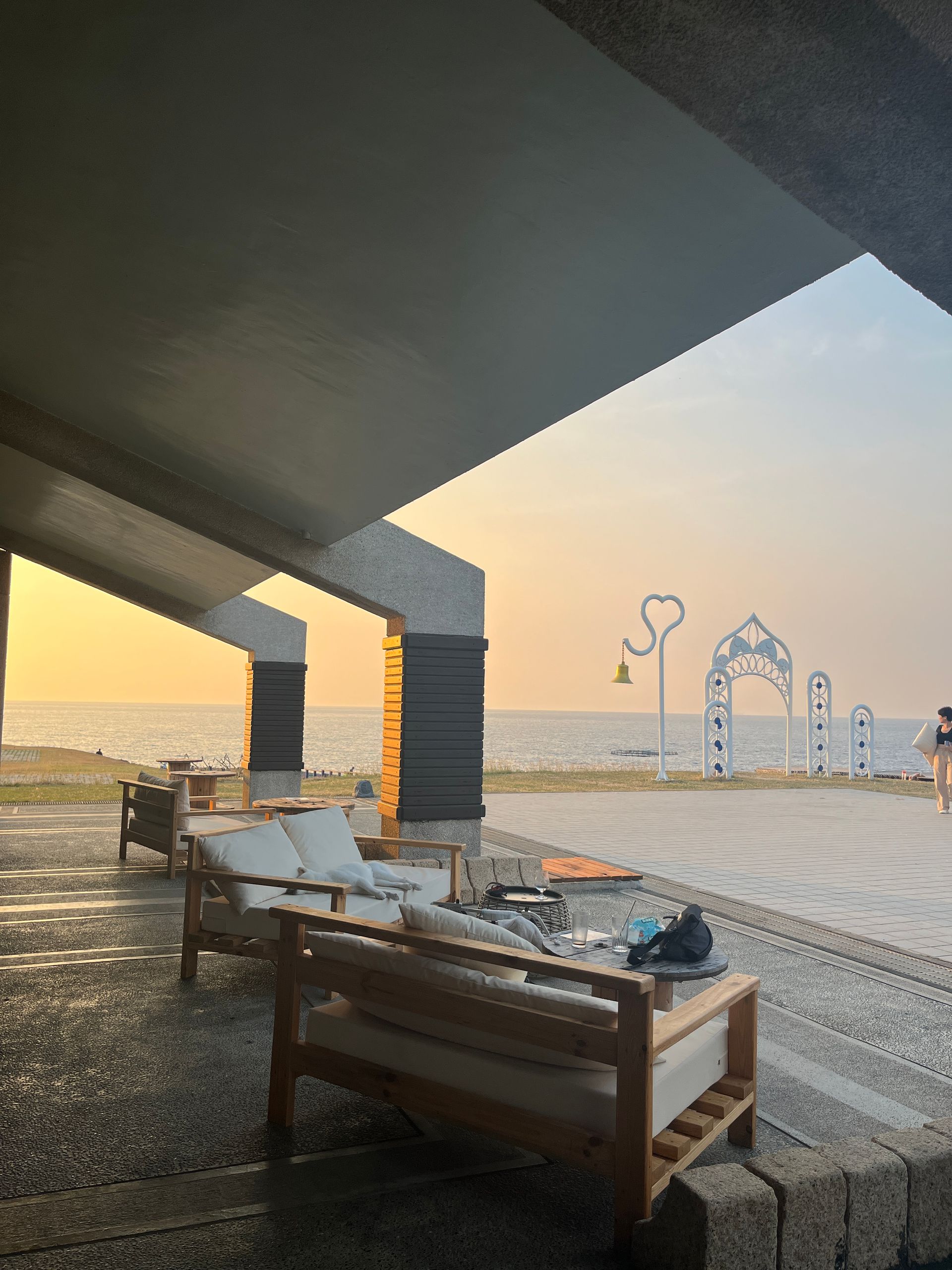 A view of the ocean from under a bridge