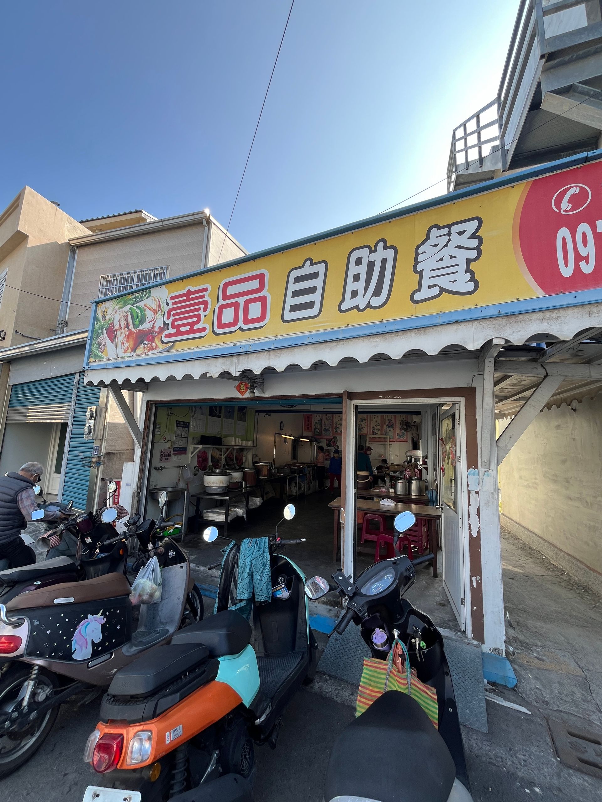 a row of scooters are parked in front of a restaurant .