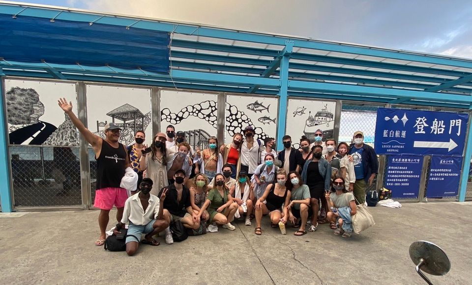 A group of people are posing for a picture in front of a building.