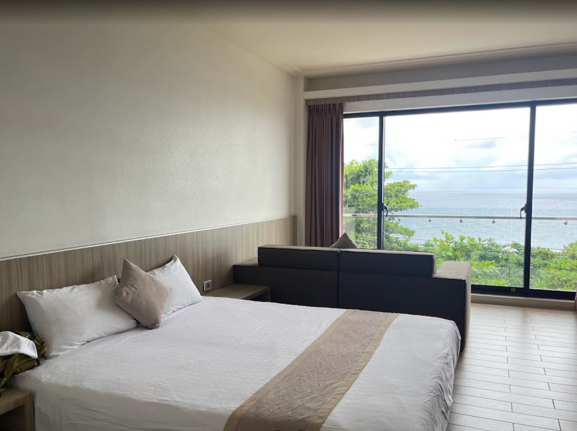 A hotel room with a large bed and a couch.