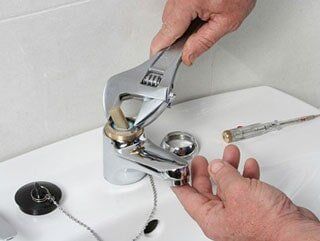Man providing a faucet repair — drain cleaning Sebring FL
