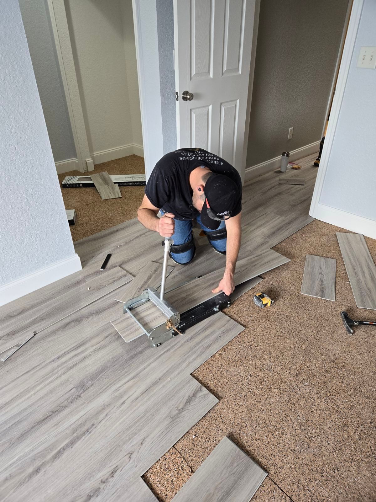 Man Cutting a Laminated Wooden Floor — West Palm Beach, FL — Arguedas Remodeling Services & Design
